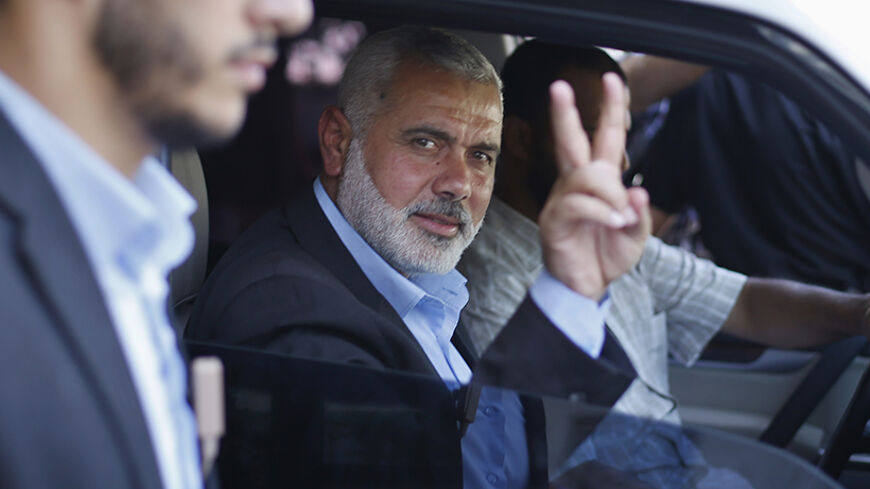 Senior Hamas leader Ismail Haniyeh gestures as leaves his office as a former Hamas government Prime Minister, in Gaza City June 2, 2014. President Mahmoud Abbas swore in a Palestinian unity government on Monday under a reconciliation deal with Hamas Islamists that led Israel to freeze U.S.-brokered peace talks with the Western-backed leader. REUTERS/Suhaib Salem  (GAZA - Tags: POLITICS) - RTR3RTYV