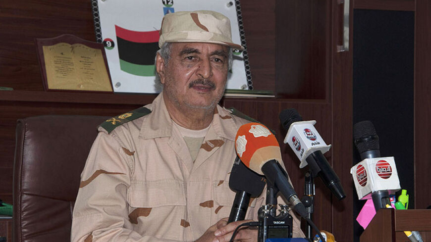 Ex-general Khalifa Haftar speaks during a news conference after surviving an assassination attempt, in Al Marj, east of Benghazi June 4, 2014. Gunmen in Libya shot dead a Swiss national working for the International Committee of the Red Cross (ICRC), fired a grenade at the prime minister's office and tried to kill Haftar, in a series of attacks on Wednesday. A suicide bomber blew up a sports utility vehicle packed with explosives at retired general Haftar's base in Benghazi, according to his spokesman, Moha