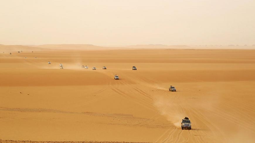 Troops and vehicles from the national army in Kufra, are seen taking part in a "Operation Dignity" mission, at the Libyan-Egyptian border, near Kufra, June 5, 2014. The operation, a self-declared campaign launched by former Libyan army officer Khalifa Haftar, is conducted against Islamist militants by irregular forces - a mixture of a mixture of militias, regular army and air force units - loyal to Haftar. Picture taken June 5, 2014. REUTERS/Stringer (LIBYA - Tags: CIVIL UNREST POLITICS MILITARY) - RTR3SQND