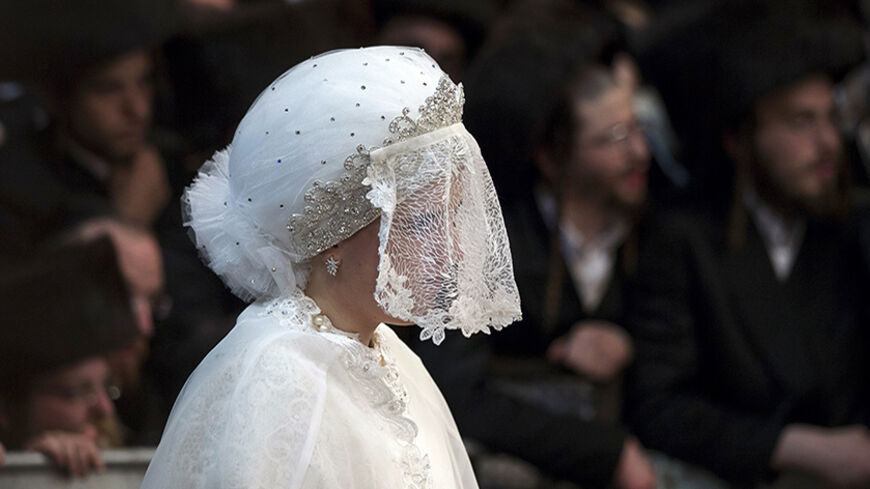 Ultra-orthodox Jewish bride Esther Rokeach waits for the start of the "mitzva tantz", the custom in which relatives dance in front of the bride after her wedding ceremony, in Jerusalem early June 11, 2014. Thousands gathered on Tuesday to celebrate the wedding of Rokeach, the granddaughter of the spiritual leader of the Belz Hasidim, which is one of the largest Hasidic movements in the world.  REUTERS/Baz Ratner (JERUSALEM - Tags: RELIGION SOCIETY) - RTR3T7BC