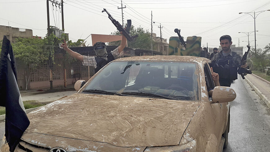 Fighters of the Islamic State of Iraq and the Levant (ISIL) celebrate on vehicles taken from Iraqi security forces, at a street in city of Mosul, June 12, 2014. Since Tuesday, black clad ISIL fighters have seized Iraq's second biggest city Mosul and Tikrit, home town of former dictator Saddam Hussein, as well as other towns and cities north of Baghdad. They continued their lightning advance on Thursday, moving into towns just an hour's drive from the capital. Picture taken June 12, 2014. REUTERS/Stringer (I