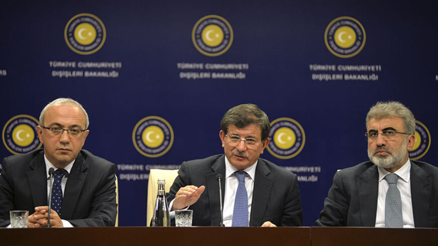 Turkey's Foreign Minister Ahmet Davutoglu (C), Energy Minister Taner Yildiz (R) and Transport Minister Lutfi Elvan attend a news conference in Ankara June 13, 2014. Turkish officials, from the normally vocal Prime Minister Tayyip Erdogan down, have made little public comment on events in Iraq. Their top priority, they say, is the delicate process of ensuring the release of 80 Turks, including diplomats, special forces soldiers and children, snatched by Islamic State in Iraq and the Levant (ISIL) as it seize