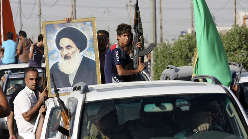 Volunteers, who have joined the Iraqi Army to fight against predominantly Sunni militants, carry weapons and a portrait of Grand Ayatollah Ali al-Sistani during a parade in the streets in Baghdad's Sadr city June 14, 2014. An offensive by insurgents that threatens to dismember Iraq seemed to slow on Saturday after days of lightning advances as government forces regained some territory in counter-attacks, easing pressure on the Shi'ite-led government in Baghdad.  REUTERS/Wissm al-Okili   (IRAQ - Tags: CIVIL 