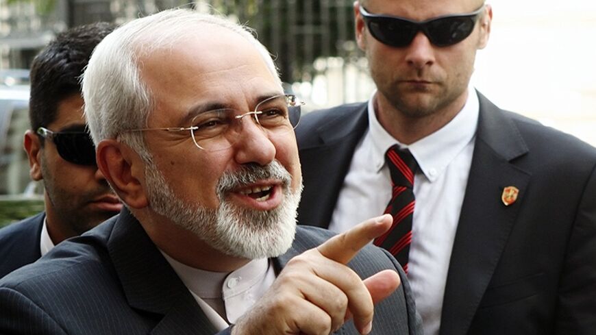 Iranian Foreign Minister Mohammad Javad Zarif talks to journalists as he arrives at his embassy in Vienna June 16, 2014. Zarif is in Vienna for a new round of talks between world powers and Iran on Tehran's contested nuclear programme. REUTERS/Heinz-Peter Bader (AUSTRIA - Tags: POLITICS ENERGY) - RTR3U1EB
