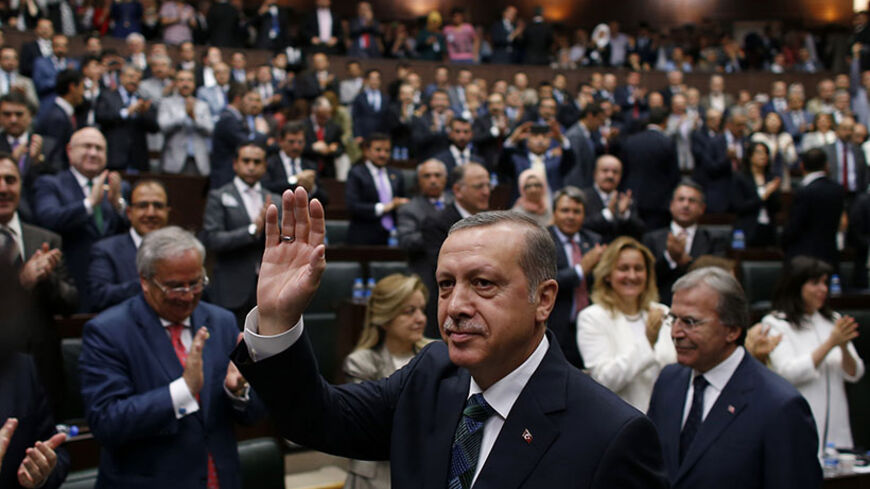 Turkey's Prime Minister Tayyip Erdogan greets members of parliament from his ruling AK Party (AKP) as he arrives for a meeting at the Turkish parliament in Ankara June 17, 2014. REUTERS/Umit Bektas (TURKEY - Tags: POLITICS) - RTR3U7QZ