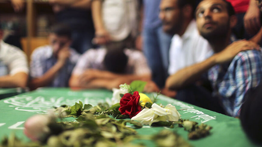 Mourners surround the bodies of Palestinian members of Hamas' armed wing during their funeral at a mosque in Gaza City June 21, 2014. Hamas' armed wing in Gaza said at least six members of its group were killed in the collapse of a tunnel the group had dug close to the border with Israel to infiltrate the Jewish state. REUTERS/Mohammed Salem (GAZA - Tags: POLITICS CIVIL UNREST) - RTR3UZ0H