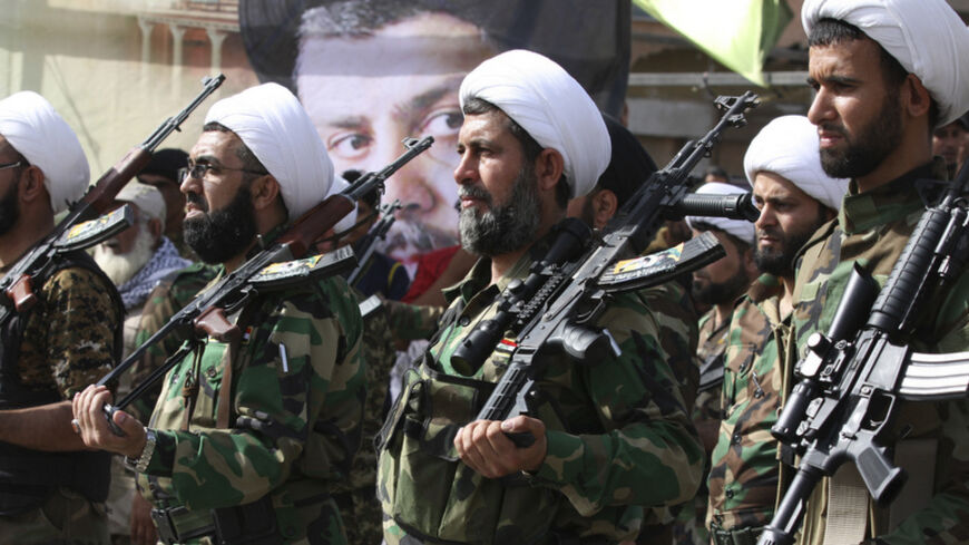 Mehdi Army fighters loyal to Shi'ite cleric Moqtada al-Sadr march during a parade in Baghdad's Sadr city, June 21, 2014.  Iraq's senior Shi'ite religious cleric Moqtada al-Sadr issued a call for unity, saying Shi'ites and Sunnis should rally behind the authorities to prevent the Sunni militant Islamic State of Iraq and the Levant from destroying the country. REUTERS/Wissm al-Okili (IRAQ - Tags: CIVIL UNREST POLITICS MILITARY) - RTR3UZ9R