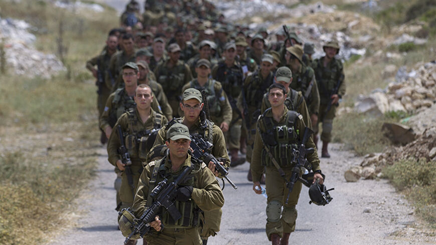 Israeli soldiers take part in searches for three Israeli teenagers believed to have been abducted by Palestinians near the West Bank City of Hebron June 21, 2014. Israel sent more troops to the occupied West Bank on Saturday to search for three missing teenagers it says were abducted by Palestinian Islamist group Hamas.
 REUTERS/Baz Ratner(WEST BANK - Tags: CIVIL UNREST MILITARY POLITICS) - RTR3UZBB