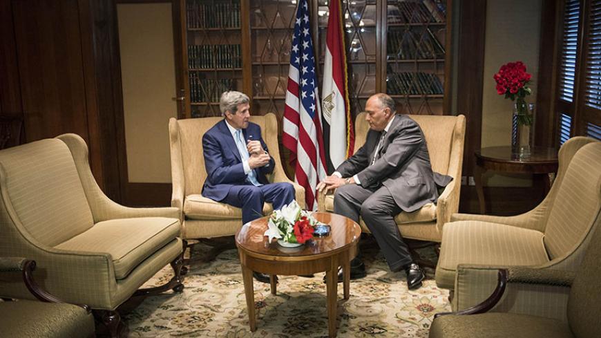 U.S. Secretary of State John Kerry (L) meets with Egyptian Foreign Minister Sameh Shoukri in the capital Cairo June 22, 2014. Kerry arrived in Cairo on Sunday for talks with Egypt's President Abdel Fattah al-Sisi over Egypt's crackdown on the Muslim Brotherhood and the threat which the conflict in Iraq poses to the Middle East. REUTERS/Brendan Smialowski/Pool (EGYPT - Tags: POLITICS) - RTR3V2SV