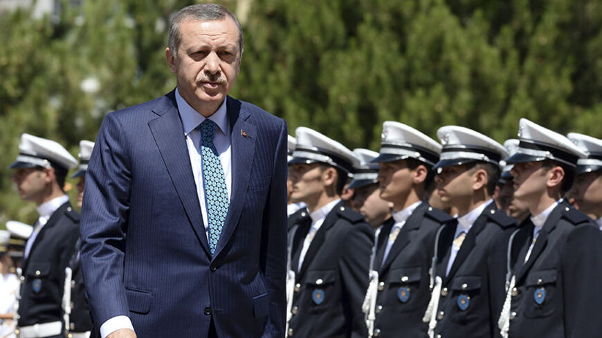 Turkey's Prime Minister Tayyip Erdogan reviews students of the Police Academy upon his arrival to their graduation ceremony in Ankara June 24, 2013. REUTERS/Stringer (TURKEY - Tags: POLITICS CRIME LAW) - RTX10YXL