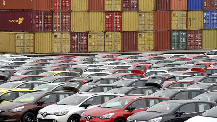 Renault cars produced in Turkey and awaiting export throughout Europe, are lined-up in front of ship containers in the port of Koper October 14, 2013. Automotive industry association ACEA said October 16, 2013, that new car registrations in Europe climbed 5.5 percent to 1.19 million vehicles in September, only the third month a gain was recorded in the past two years. But within the European Union, the level of demand was the second lowest on record for the month of September since it began tabulating resul
