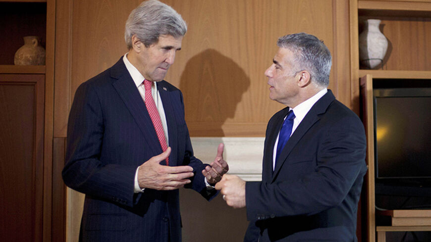 U.S. Secretary of State John Kerry (L) talks to Israel's Finance Minister Yair Lapid before their meeting in Jerusalem December 6, 2013. REUTERS/Pablo Martinez Monsivais/Pool (JERUSALEM - Tags: POLITICS BUSINESS) - RTX1665G