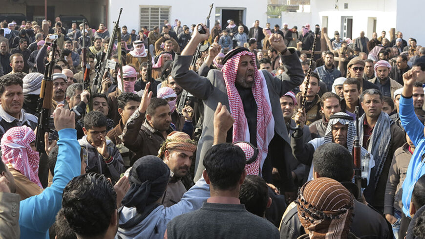 Residents gather to protest near the house of prominent Sunni Muslim lawmaker Ahmed al-Alwani, in the centre of Ramadi, December 29, 2013. Iraqi security forces arrested Alwani in a raid on his home in the western province of Anbar, sparking clashes in which at least five people were killed, police sources said. Picture taken December 29, 2013.  REUTERS/Ali al-Mashhadani (IRAQ - Tags: POLITICS CIVIL UNREST) - RTX16X7M