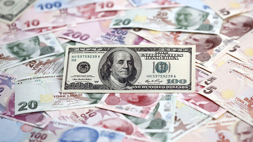 A photo illustration taken in Istanbul shows a U.S. 100 dollar banknote against Turkish lira banknotes of various denominations January 7, 2014. Turkey's lira slipped against the U.S. dollar on Wednesday as the government bond yield curve, which had briefly inverted on Tuesday because of speculation about an emergency rate hike to rescue the currency, returned to a positive slope. Picture taken January 7, 2014. REUTERS/Murad Sezer (TURKEY - Tags: BUSINESS) - RTX1761E