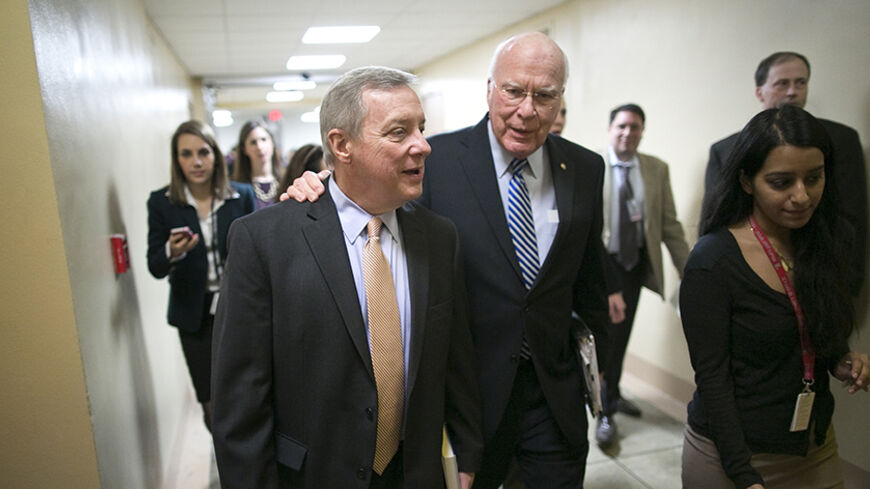 U.S. Senator Dick Durbin (D-IL) (L) talks to Senator Pat Leahy (D-VT) (C) as they arrive for the weekly Democratic caucus luncheon at the U.S. Capitol in Washington, February 4, 2014.  REUTERS/Jonathan Ernst    (UNITED STATES - Tags: POLITICS) - RTX187YG