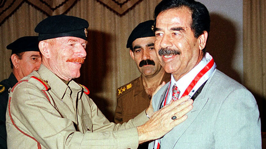 - PHOTO TAKEN 12MAY1999 - Former Iraqi president Saddam Hussein (R) is decorated with a medal presented to him by his deputy Izzat Ibrahim in Baghdad in this May 12, 1999 file photo. Ibrahim, the most senior member of the former regime, has died, [Al Arabiya satellite television quoted a Baath party statement as saying on Friday.] He is number six on the U.S. military's list of the 55 most-wanted Iraqis, with a $10 million reward offered for his capture. - RTXNYC5