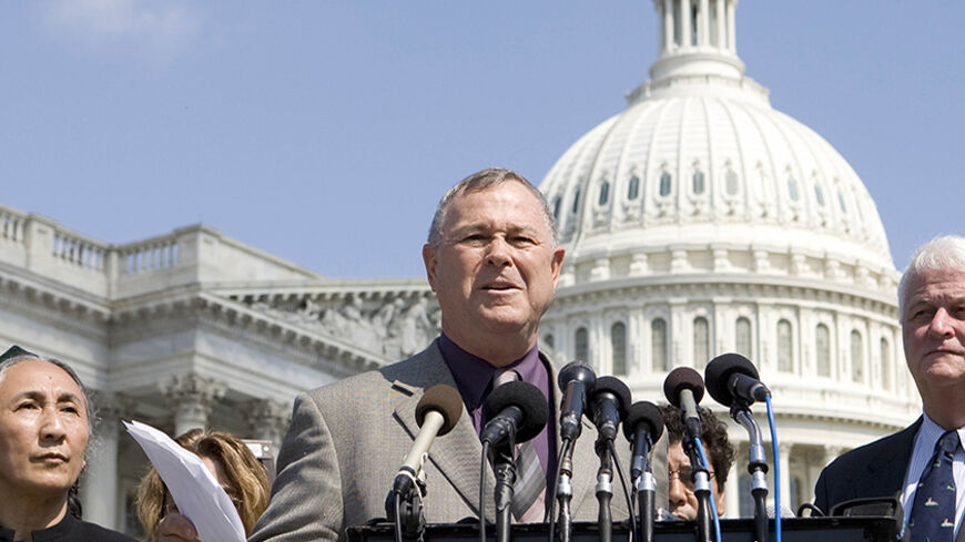 U.S. Rep. Dana Rohrabacher (C) and U.S. Rep. William Delahunt (R) are joined by World Uighur Congress President Rebiya Kadeer (L) as they hold a news conference to introduce a U.S. House resolution about the Uighur protests while outside the U.S. Capitol in Washington, July 10, 2009.      REUTERS/Larry Downing (UNITED STATES POLITICS) - RTR25J6S