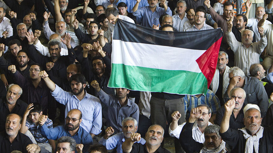 EDITORS' NOTE: Reuters and other foreign media are subject to Iranian restrictions on their ability to film or take pictures in Tehran.

Iranians shout anti-U.S. and anti-Israel slogans as one of them holds a Palestinian flag during Friday prayers after the Jerusalem Day demonstration in Tehran September 3, 2010. REUTERS/Raheb Homavandi (IRAN - Tags: POLITICS RELIGION) - RTR2HV3V