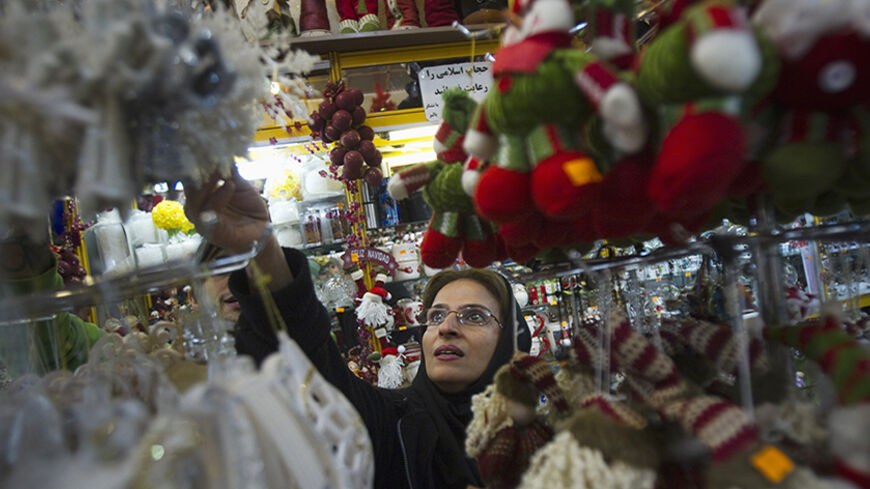 An Iranian-Christian woman looks at Christmas decorations while shopping in central Tehran December 13, 2011. REUTERS/Morteza Nikoubazl (IRAN - Tags: SOCIETY RELIGION) - RTR2V75E