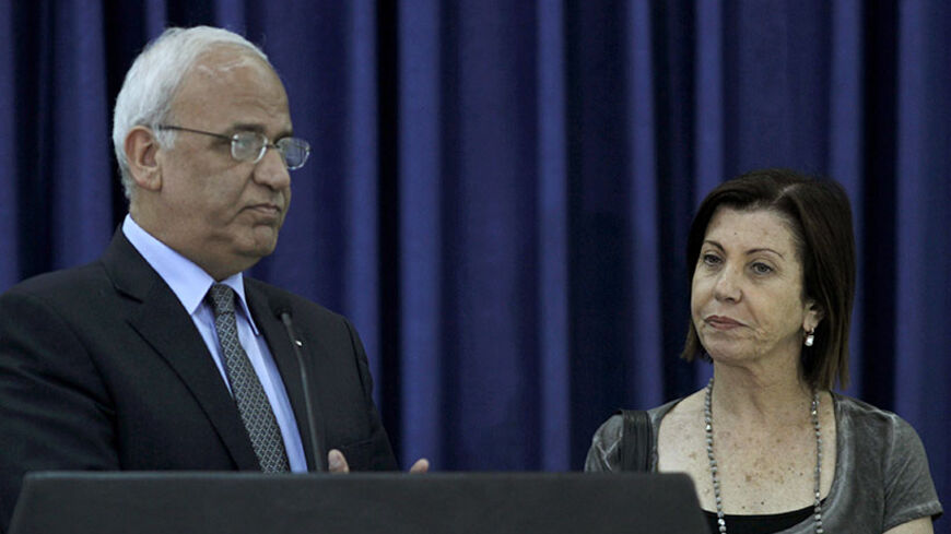 Chief Palestinian negotiator Saeb Erekat (L) and Israeli lawmaker Zahava Gal-On, leader of the left-wing Meretz party, give a statement to the media in the West Bank city of Ramallah August 26, 2012. REUTERS/Mohamad Torokman (WEST BANK - Tags: POLITICS) - RTR3754Z