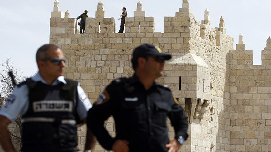 Israeli policemen stand guard at Damascus Gate in Jerusalem's Old City March 15, 2013. Israeli police declared an age limit on Friday for Palestinians wanting to enter the Old City, only allowing males above the age of 50 and all females to enter. REUTERS/Amir Cohen (JERUSALEM - Tags: SOCIETY) - RTR3F156
