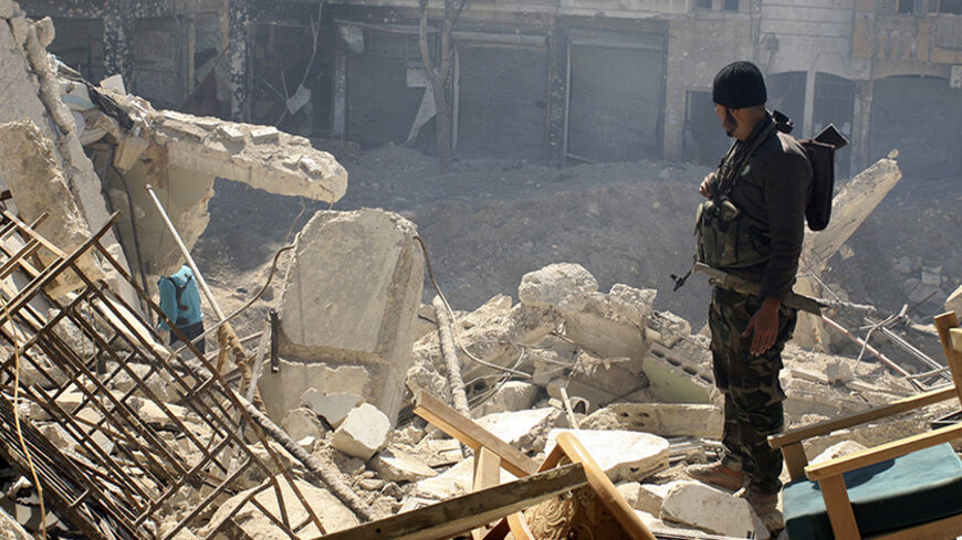 A Free Syrian Army (FSA) fighter stands near a crater left by an explosion of a mine planted by the FSA during their offensive against forces loyal to Syria's President Bashar al-Assad, to take control of the compound of the justice palace in the old city of Aleppo, March 19, 2014. The FSA claimed to have taken control of the justice palace. REUTERS/Abdalrhman Ismail (SYRIA - Tags: POLITICS CIVIL UNREST CONFLICT) - RTR3HSBM