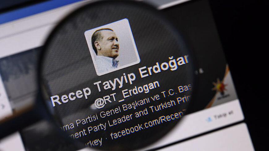 An image of Turkish Prime Minister Tayyip Erdogan on a twitter account is pictured through a magnifying glass in this illustration picture taken in Istanbul March 21, 2014. Turkey's courts have blocked access to Twitter days before elections as Prime Minister Tayyip Erdogan battles a corruption scandal that has seen social media platforms awash with alleged evidence of government wrongdoing. The ban came hours after a defiant Erdogan, on the campaign trail ahead of key March 30 local elections, vowed to "wi