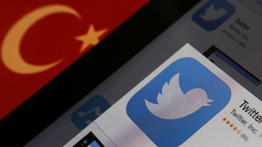 A Twitter logo on an iPad display is pictured next to a Turkish flag in this photo illustration taken in Istanbul March 21, 2014. Turkey's courts have blocked access to Twitter a little over a week before elections as Prime Minister Tayyip Erdogan battles a corruption scandal that has seen social media awash with alleged evidence of government wrongdoing. The ban came hours after a defiant Erdogan, on the campaign trail ahead of key March 30 local elections, vowed to "wipe out" Twitter and said he did not c
