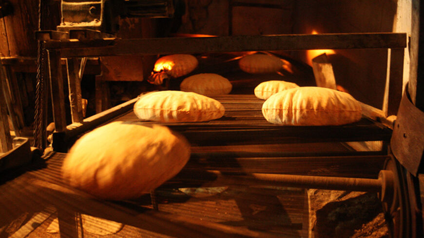 Bread are baked in a bakery in Old Aleppo March 29, 2014. REUTERS/Abdalrhman Ismail (SYRIA - Tags: SOCIETY FOOD) - RTR3J4I9