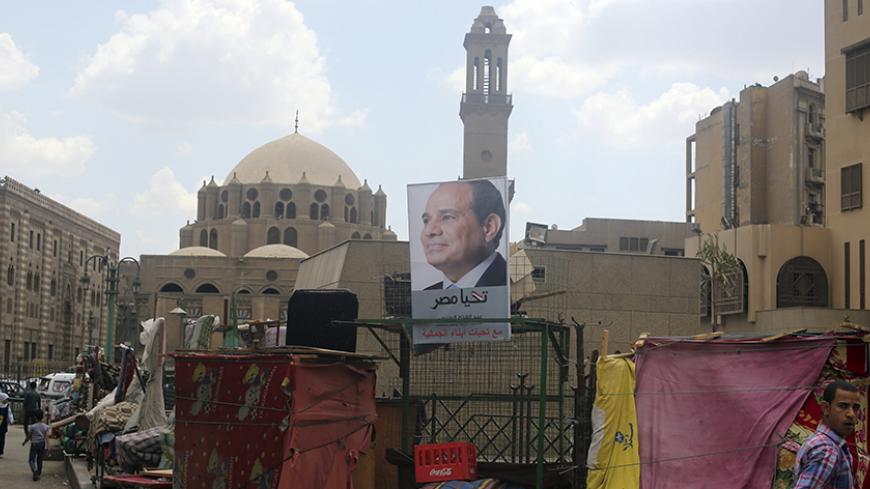 A poster of Egypt's former army chief Abdel Fattah al-Sisi is seen at a stall, with the Al-Azhar Mosque in the background, in the old Islamic area of Cairo May 8, 2014. As the Egyptian state presses its crackdown on the Muslim Brotherhood, the man expected to become president has deployed a new weapon in the battle with the Islamists: his own vision of Islam. Sisi, the former army chief who deposed the Brotherhood's Mohamed Mursi and is expected to be elected president later this month, has cast himself as 