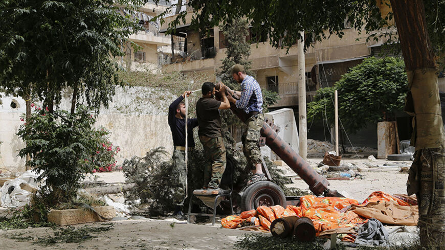 Members of Islamist rebel group al-Nusra Front prepare a home made mortar in Aleppo's Bustan al-Qasr neighborhood June 5, 2014. REUTERS/Hamid Khatib (SYRIA - Tags: POLITICS CIVIL UNREST CONFLICT) - RTR3SE8K