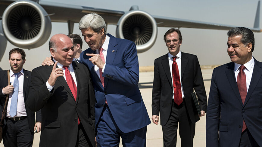 U.S. Secretary of State John Kerry (centre, R) talks with Fuad Hussein (centre,L), chief of staff at the presidency of the Kurdistan Regional Government, while accompanied by Kurdish regional foreign relations minister Falah Mustafa Bakir (R) and other officials, at Arbil International Airport  June 24, 2014. Kerry was in Iraqi Kurdistan on Tuesday to urge its leaders not to withdraw from the political process in Baghdad after their forces took control of the northern oil city of Kirkuk. Peshmerga fighters,