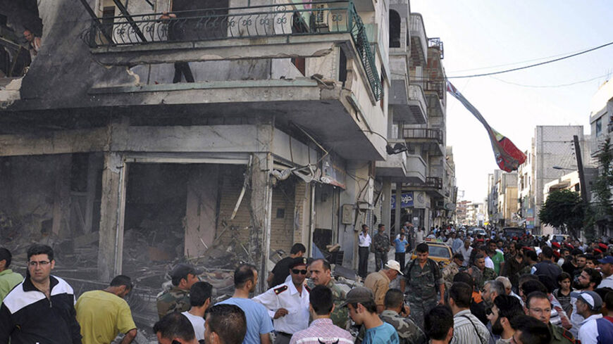 People gather around wreckage after a car bomb at the Wadi al-Thahb neighborhood in Homs city June 24, 2014, in this picture provided by Syria's national news agency SANA. The car bomb killed a woman and wounded 23, state media said. REUTERS/SANA/Handout via Reuters (SYRIA - Tags: POLITICS CONFLICT CIVIL UNREST)

ATTENTION EDITORS - THIS PICTURE WAS PROVIDED BY A THIRD PARTY. REUTERS IS UNABLE TO INDEPENDENTLY VERIFY THE AUTHENTICITY, CONTENT, LOCATION OR DATE OF THIS IMAGE. THIS PICTURE IS DISTRIBUTED EXAC