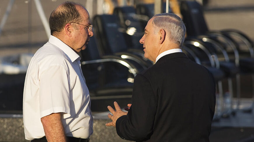 Israel's Prime Minister Benjamin Netanyahu (R) speaks with Defence Minister Moshe Ya'alon after an air force pilots' graduation ceremony at Hatzerim air base in southern Israel June 26, 2014. REUTERS/Amir Cohen (ISRAEL - Tags: MILITARY POLITICS) - RTR3VXQB