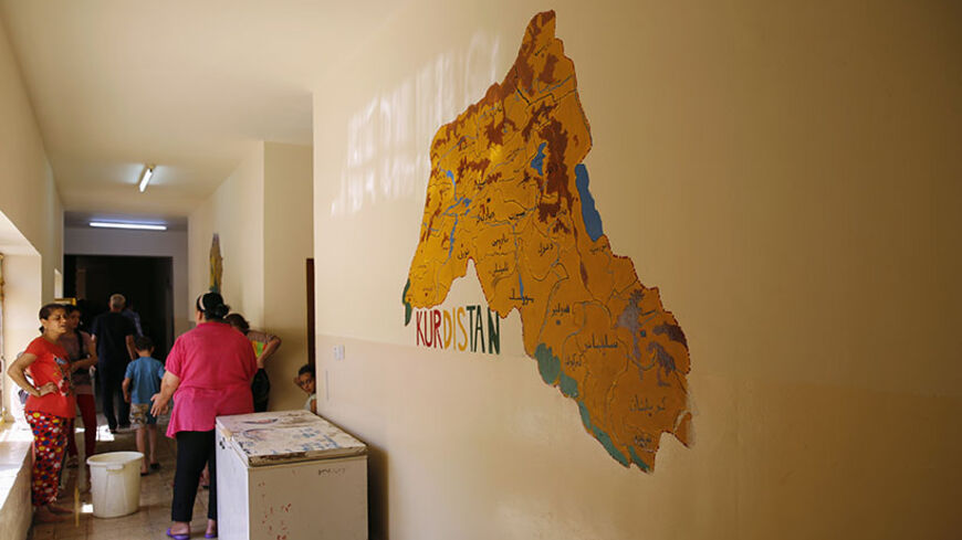 A map of the Kurdistan region is seen on the wall of a school where a Christian family who fled from the violence in Mosul two days ago, is staying in Arbil, in Iraq's Kurdistan region June 27, 2014. Iraqi forces launched an airborne assault on rebel-held Tikrit on Thursday with commandos flown into a stadium in helicopters, at least one of which crashed after taking fire from insurgents who have seized northern cities. REUTERS/Ahmed Jadallah (IRAQ - Tags: CIVIL UNREST POLITICS CONFLICT SOCIETY) - RTR3W0Y0