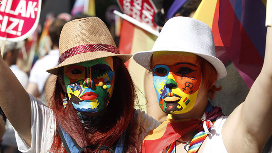 Participants wearing masks attend a gay pride parade in central Istanbul June 29, 2014.   REUTERS/Osman Orsal (TURKEY - Tags: CIVIL UNREST SOCIETY POLITICS) - RTR3WB45