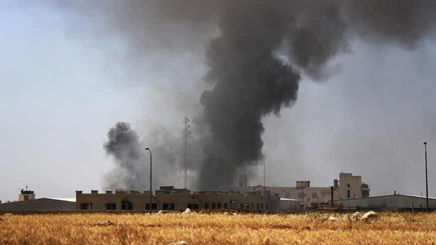 Smoke rises during what activists said were clashes between rebel fighters and forces loyal to Syria's President Bashar al-Assad in Aleppo's Sheikh Najjar frontline June 30, 2014. REUTERS/Hamid Khatib   (SYRIA - Tags: POLITICS CIVIL UNREST CONFLICT) - RTR3WHOA