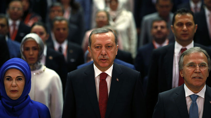 Turkey's Prime Minister Tayyip Erdogan (C), his wife Emine Erdogan and Deputy Chairman of AK Party (AKP) Mehmet Ali Sahin attend a meeting where he is named as his party's candidate for the country's first direct presidential election in Ankara July 1, 2014. Tayyip Erdogan declared his candidacy on Tuesday for a more powerful presidency which rivals fear may entrench authoritarian rule and supporters, especially conservative Muslims, see as the crowning prize in his drive to reshape NATO member Turkey. REUT