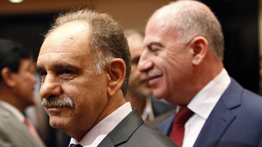 Iraq's Deputy Prime Minister Saleh al-Mutlaq (L) attends a session at the parliament headquarters in Baghdad July 1, 2014. Newly elected Iraqi lawmakers convene on Tuesday, under pressure to name a unity government to keep the country from splitting apart after an onslaught by Sunni Islamists who have declared a "caliphate" to rule over all the world's Muslims.       REUTERS/Thaier Al-Sudani  (IRAQ - Tags: POLITICS) - RTR3WMDF