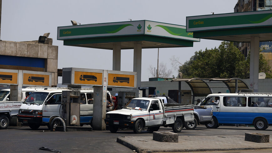 A microbus waits with other vehicles for fuel at a petrol station in Cairo July 6, 2014. Egypt's Prime Minister Ibrahim Mehleb has sought to justify politically sensitive subsidy cuts on fuel and natural gas which took effect on Saturday, saying they were a necessary part of fixing an economy hammered by three years of turmoil. Egypt had overnight on Friday slashed its subsidies for car fuel and natural gas, increasing their prices by more than 70 percent. REUTERS/Amr Abdallah Dalsh  (EGYPT - Tags: POLITICS
