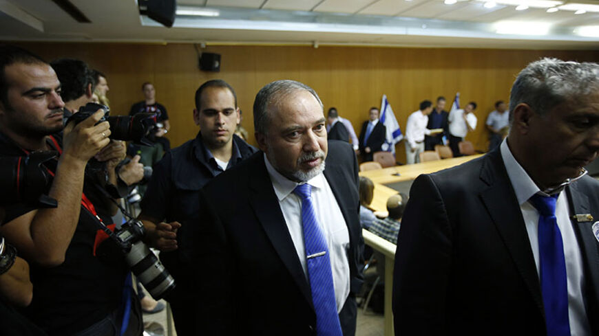 Israel's Foreign Minister Avigdor Lieberman (C) leaves after holding a news conference at parliament in Jerusalem July 7, 2014. REUTERS/Ronen Zvulun (JERUSALEM - Tags: POLITICS) - RTR3XFO1