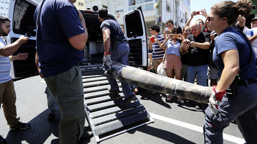 Police explosive experts load the remains of a rocket into a van after it was intercepted by Israel's Iron Dome aerial defense system, in Tel Aviv July 11, 2014. Israeli air strikes on Gaza killed four more Palestinians before dawn on Friday, raising the death toll from the four day offensive to at least 85, while a Palestinian rocket hit a fuel tanker at an Israeli petrol station causing a huge blaze. REUTERS/Yaron Brener/Ynet (ISRAEL - Tags: POLITICS CIVIL UNREST MILITARY CONFLICT) ISRAEL OUT. NO COMMERCI