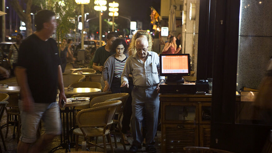 Diners go for shelter inside a restaurant as an air raid siren, warning of incoming rockets, sounds in a main street in Tel Aviv July 11, 2014. Prime Minister Benjamin Netanyahu said on Friday Israel has attacked more than 1,000 targets during a four-day-old offensive against Gaza militants and that "there are still more to go". REUTERS/Nir Elias (ISRAEL - Tags: POLITICS CIVIL UNREST CONFLICT) - RTR3Y7ZJ