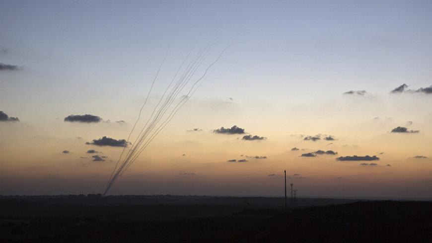 Smoke trails are seen as rockets are launched towards Israel from the northern Gaza Strip July 13, 2014. Thousands fled their homes in a Gaza town on Sunday after Israel warned them to leave ahead of threatened attacks on rocket-launching sites, on the sixth day of an offensive that Palestinian officials said has killed at least 160 people. Militants in the Hamas-ruled Gaza Strip kept up rockets salvoes deep into the Jewish state and the worst bout of Israel-Palestinian bloodshed in two years showed no sign
