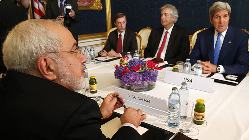 Iran's Foreign Minister Javad Zarif (L) holds a bilateral meeting with U.S. Secretary of State John Kerry (R) on the second straight day of talks over Tehran's nuclear program in Vienna, July 14, 2014. Kerry will press his Iranian counterpart Zarif to make "critical choices" in a second straight day of talks over Tehran's nuclear program on Monday, a U.S. official said.  REUTERS/Jim Bourg (AUSTRIA - Tags: POLITICS ENERGY) - RTR3YJOX