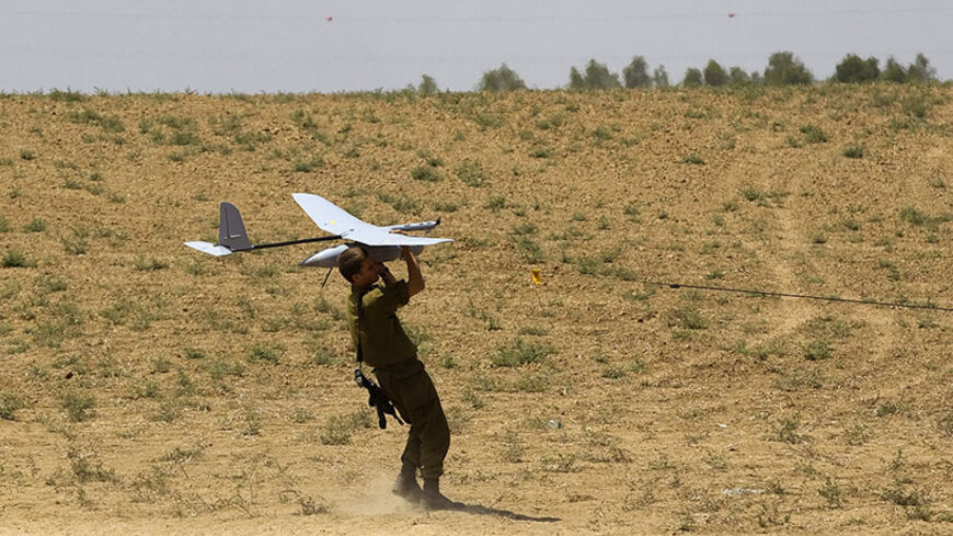 An Israeli soldier launches a Skylark unmanned aerial vehicle near the border with Gaza July 21, 2014. Israeli forces killed 10 Palestinian militants who slipped across the border from Gaza through hidden tunnels on Monday, the military said, as the death toll from the two-week conflict passed 500 amid growing international calls for an end. Non-stop attacks lifted the Palestinian death toll to 496, including almost 100 children, since fighting started on July 8, Gaza health officials said. Israel says 18 o