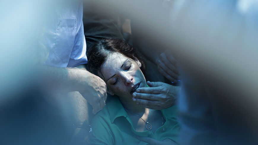 Dana, the sister of Israeli soldier Tsafrir Bar-Or, mourns during his funeral in Holon near Tel Aviv July 21, 2014. Israeli forces killed 10 Palestinian militants who slipped across the border from Gaza through hidden tunnels on Monday, the military said, as the death toll from the two-week conflict passed 500 amid growing international calls for an end. Non-stop attacks lifted the Palestinian death toll to 496, including almost 100 children, since fighting started on July 8, Gaza health officials said. Isr