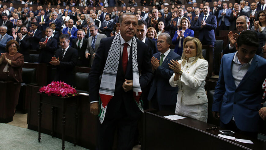 Turkey's Prime Minister Tayyip Erdogan leaves his seat to address members of parliament from his ruling AK Party (AKP) during a meeting at the Turkish parliament in Ankara  July 22, 2014. REUTERS/Umit Bektas (TURKEY - Tags: POLITICS) - RTR3ZNA6