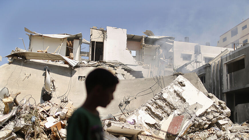 A Palestinian boy walks past the remains of a house which witnesses said was destoyed by an Israeli air strike, in Gaza City July 23, 2014. Israeli forces pounded the Gaza Strip on Wednesday, sending thousands of residents fleeing, and said it was meeting stiff resistance from Hamas Islamists, as U.S. Secretary of State John Kerry flew to Tel Aviv to push ceasefire talks. Israel launched its offensive on July 8 to halt missile salvoes by Hamas Islamists, who were struggling under the weight of an Israeli-Eg