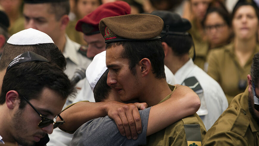 An Israeli soldier from the Golani Brigade mourns during the funeral for fallen comrade Max Steinberg at Mount Herzl military cemetery in Jerusalem July 23, 2014. Steinberg, a 23 year-old American from California's San Fernando Valley, was among 13 Israeli Defense Forces soldiers killed on Sunday during fighting in Gaza. REUTERS/Siegfried Modola (JERUSALEM - Tags: CONFLICT POLITICS CIVIL UNREST MILITARY) - RTR3ZTAC